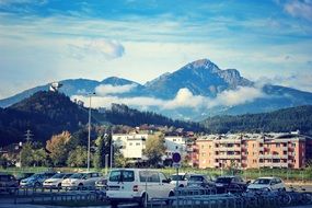 cars on parking in city at scenic mountains, Austria, Innsbruck