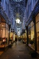 narrow street decorated with lights garlands