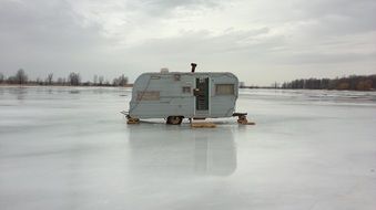 ice fishing hut on a lake in winter in Canada