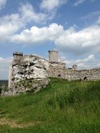 castle ruins on a green hill on beautiful landscape in Poland