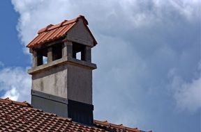 brick chimney over a large roof