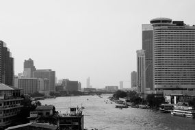 Black and white photo of the skyscrapers near the river in thailand