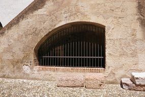 Window grilles in stone building in Italy