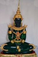 colorful statue of jade buddha in meditation