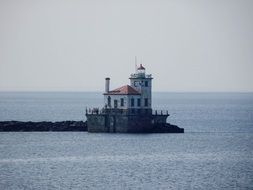 lighthouse in the water in the ocean