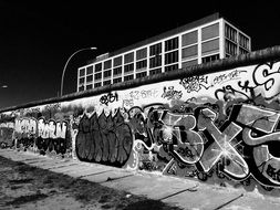 black and white photo of a wall with graffiti in Berlin