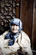 portrait of an old woman near the wall