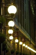 A lot of street lamps on a street at night