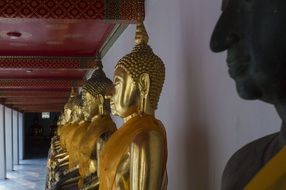 golden buddha statues in temple in Thailand