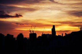 urban buildings against the orange sky during sunset