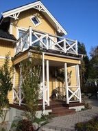 country style House with balcony above Porch