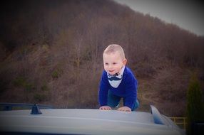 crawling baby boy at the background of forest