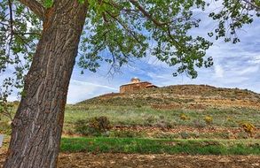 distant view of a stone fortress on a hill