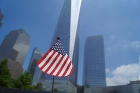 american flag against the background of skyscrapers, usa, manhattan, nyc