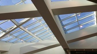 bottom view of modern glass and concrete ceiling construction