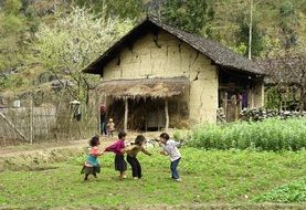 four children playing on green grass