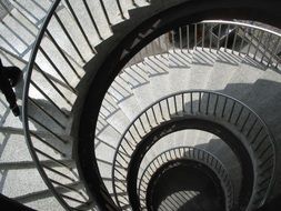 black and white photo of a spiral staircase in a building