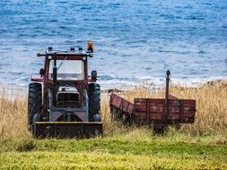 old agriculture Tractor near the water