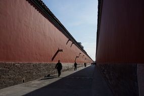 people walk down the street in the forbidden city