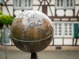 bronze globe among city street