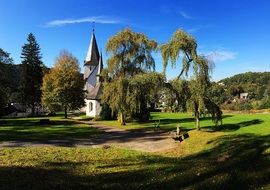 church among green trees and fields