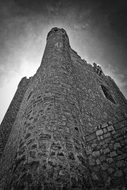 medieval stone tower at sky, bottom view