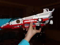 lego weapon in the hand of a child