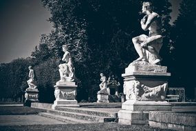 Black and white photo of the Stone sculptures among the plants