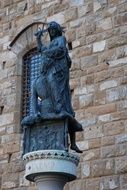 black sculpture near the wall in florence