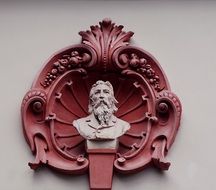 bust of a man in a seashell on the wall