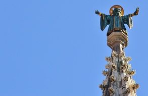 statue on the steeple of the monastery
