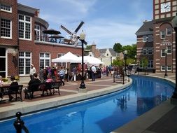 people resting at canal in city, usa, Iowa, Pella