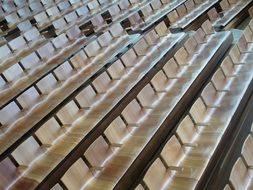 rows of wooden chairs in the theater