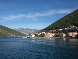 houses on the coast near the mountain