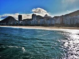 sunny beach with buildings on the coast in Rio de Janeiro