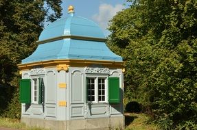 blue roofed building near green trees