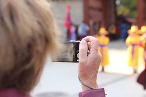 woman taking pictures of monks, korea, seoul