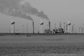 black and white photo of pipes with smoke