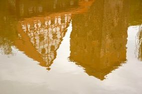 reflection of old truss buildings on water