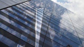 sky reflection on the glass facade of the mall