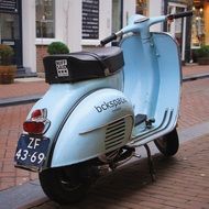bluish moped on the streets of amsterdam