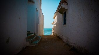 alley leading to the blue sea