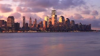 view of new york from the water at dusk