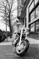 Black and white photo of motorbike on a street