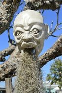 creepy face in a statue of worship