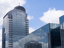 reflection of clouds and sky on a glass skyscraper