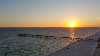 sunset over the beach in the gulf of mexico