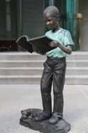 Statue of boy reading a book