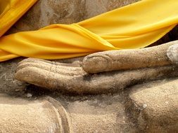 yellow cloth on the statue's arm