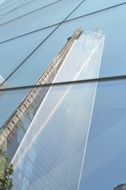 reflections of a skyscraper in a glass facade